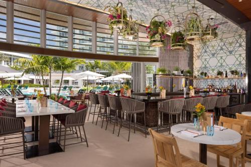 a restaurant with tables and chairs and a bar at Pier Sixty-Six in Fort Lauderdale