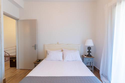 a bedroom with a white bed and a window at Pinest in Rikia
