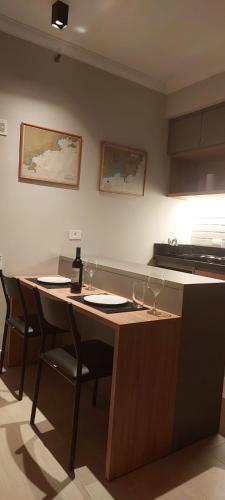a kitchen with a table with wine glasses on it at The Palace Flat Moema 1210 in São Paulo