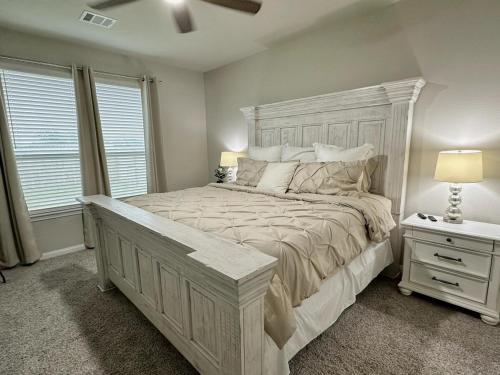a bedroom with a large bed with a wooden headboard at Aggieland Retreat in Bryan