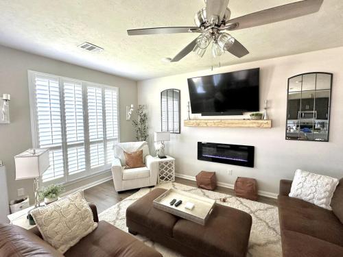 a living room with a couch and a flat screen tv at Aggieland Retreat in Bryan