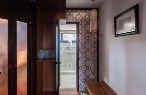a room with a glass door with a picture on the wall at Locar-in Gramado - Cond Sonnendorf - Casa 09 B in Gramado