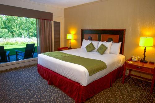 a hotel room with a bed and a large window at Jackson Lake Lodge in Moran