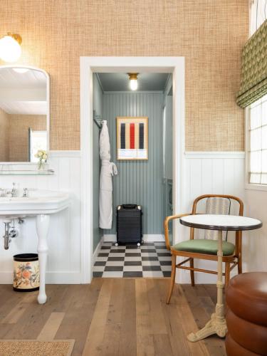 a bathroom with a sink and a table at Le Petit Pali Laguna Beach in Laguna Beach