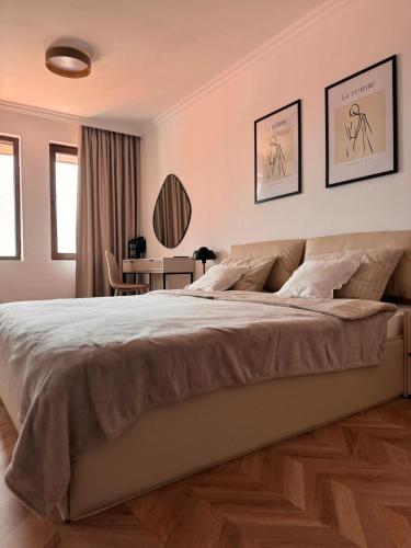 a bedroom with a large bed and a desk at SeaView Etara IV Apartment in Sveti Vlas in Sveti Vlas