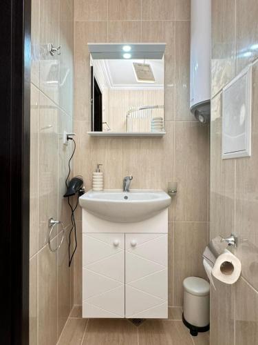 a bathroom with a sink and a mirror and a toilet at SeaView Etara IV Apartment in Sveti Vlas in Sveti Vlas
