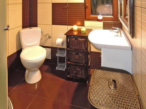 a bathroom with a toilet and a sink at Wooden House by Baltic Sea & Wolin Park in Międzyzdroje