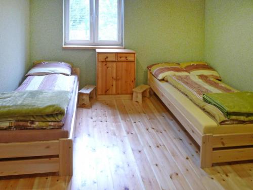 two twin beds in a room with a window at House in Wiejkowo near Szczecin Lagoon in Wiejkowo