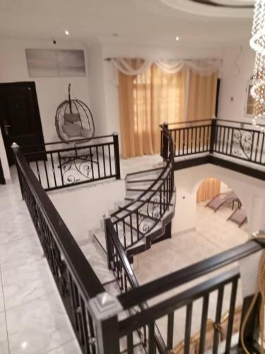 a group of stairs in a room with a chandelier at Vickkesnat Luxury Homes in Kasoa