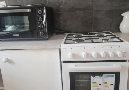 a microwave sitting on a counter next to a stove at Crisba B&B in Freetown