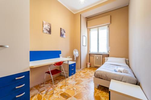 a small bedroom with a bed and a desk at Casa Lungogesso in Cuneo