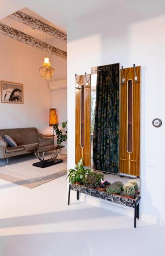 a living room with a table with plants on it at Hotel du Temps Madrid in Madrid