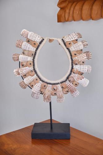 a beaded necklace on a stand on a table at Villa Te Torea in Arue