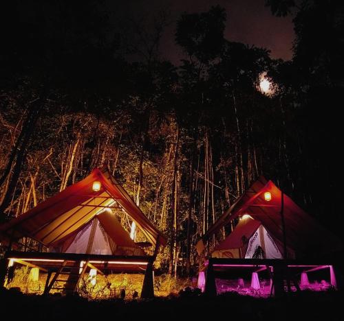 two tents at night with the moon in the background at Lainkalogos Glamping in Rabia