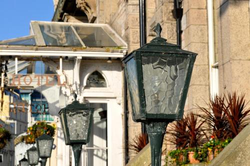 a group of three street lights in front of a building at Duke Of Cornwall Hotel in Plymouth