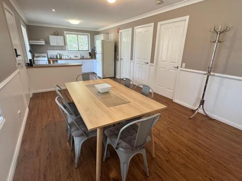 a kitchen and dining room with a table and chairs at Singleton Rose Cottages in Singleton