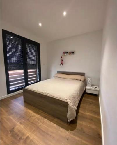 une chambre avec un grand lit et une fenêtre dans l'établissement Haut de villa avec piscine au bord de mer, à San-Martino-di-Lota