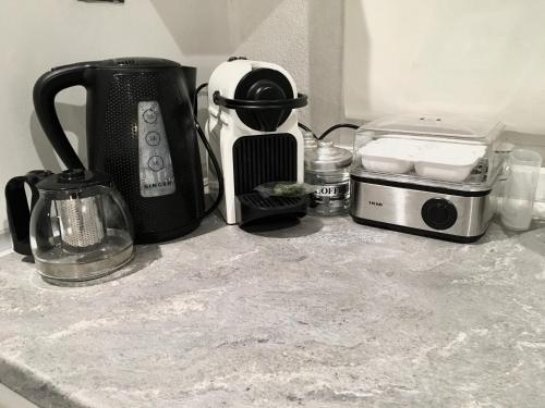 a kitchen counter with a coffee maker and a toaster at Cycladic Suite in Thessaloniki