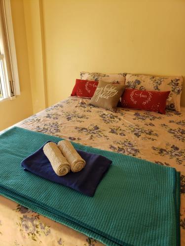 a bed with two towels on top of it at Comfortable Apartamento Semi Piso in Buenos Aires