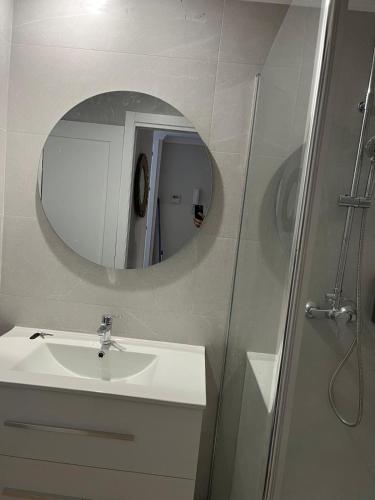 a bathroom with a sink and a mirror at Mirador de Sanlucar 3 in Sanlúcar de Barrameda