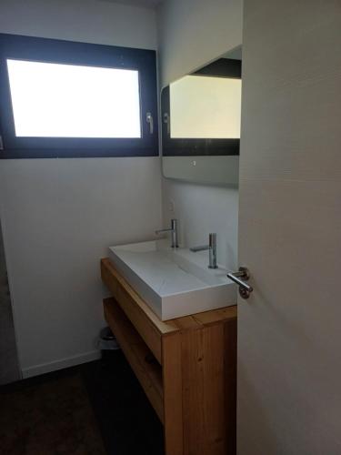 a bathroom with a white sink and a window at L 'ancienne vigne by hd - Gîte & Spa in Saint-Clair