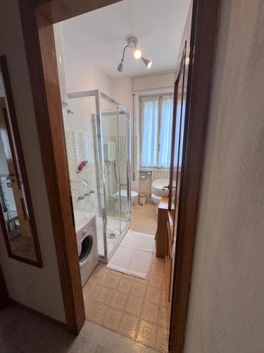 a bathroom with a shower and a glass door at Gardalba in Toscolano Maderno