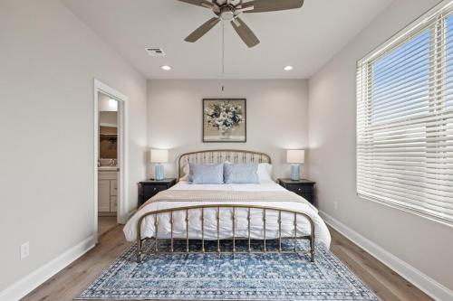 a bedroom with a bed and a ceiling fan at NEW Youngsville Escape KING Beds Cajun Luxury WiFi in Youngsville