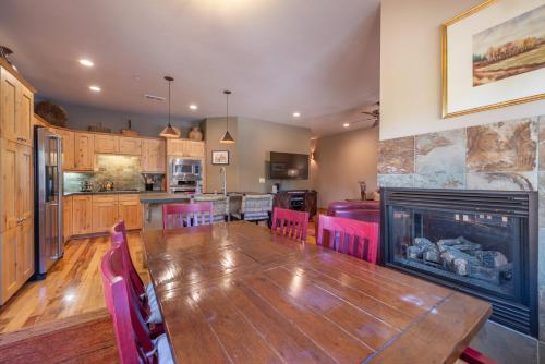 a living room with a table and a fireplace at Deluxe Truckee Townhome 3BDR Dog Friendly Great Location in Truckee