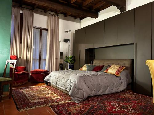 a bedroom with a large bed with a large headboard at Maison Mayr in Ferrara