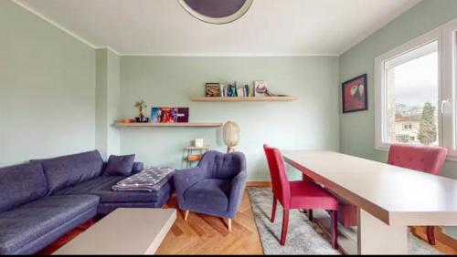 a living room with a purple couch and a table at Light T 3 air conditioning Two balconies Toulouse in Toulouse