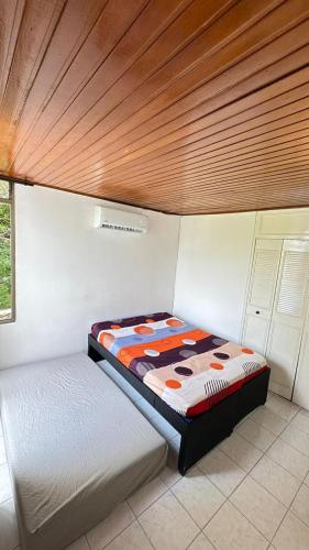 a bedroom with two beds and a wooden ceiling at APARTAMENTO FAMILIAR MELGAR CON PISCINA ac in Melgar