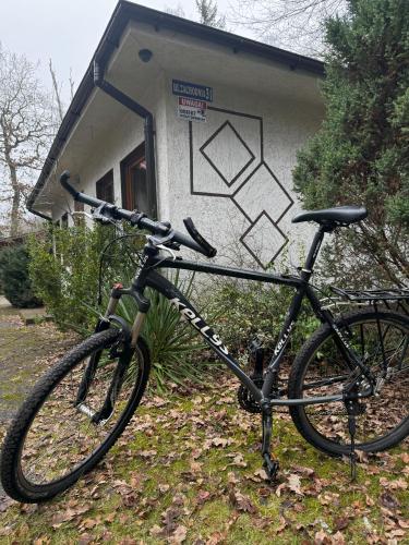 a bike parked in front of a building at ahoj PRZYLESIE in Pobierowo