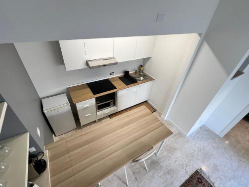 an overhead view of a kitchen with white cabinets at Luxury Pisu Apartments in Quartucciu