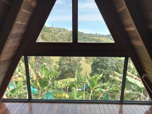 a large window in a room with a view of trees at Cabaña en Jericó in Jericó