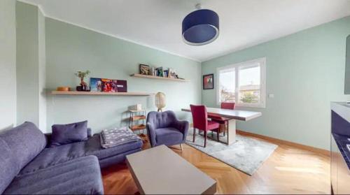 a living room with a couch and a table at Light T 3 air conditioning Two balconies Toulouse in Toulouse