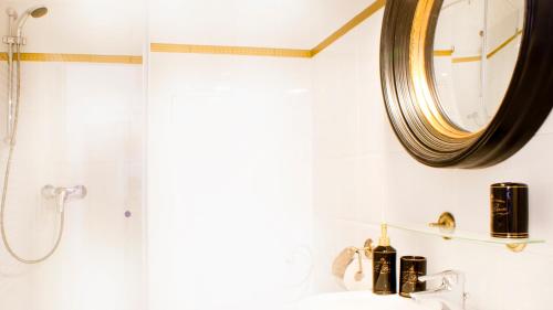 a bathroom with a sink and a mirror at Milford Suites Budapest in Budapest
