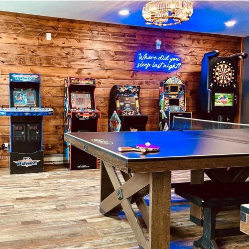 a ping pong table in a room with slot machines at The Cove Guest House in Prescott
