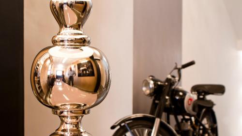 a reflection of a bike in a glass bottle next to a bicycle at Milford Suites Budapest in Budapest