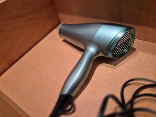 a blow dryer sitting on top of a wooden table at Apartment am Wald in Gauting, ideal mit Hund in Gauting