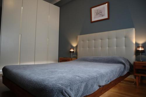 a bedroom with a large bed with a blue blanket at Apartamento Moderno e Acolhedor I Perto do Aeroporto in Lisbon