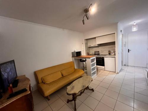 un salon avec un canapé et une cuisine dans l'établissement Large Studio in Cannes near la Croisette and beach, à Cannes