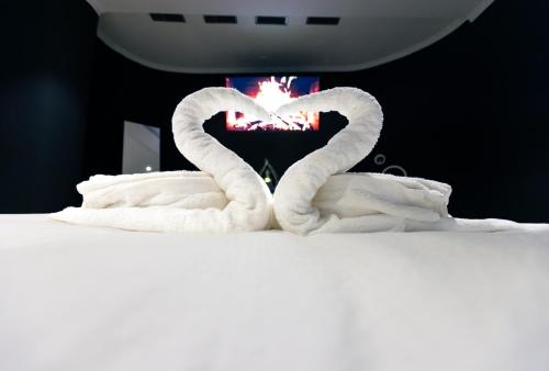 two swans making a heart on top of a bed at Blvck Spa in Brussels