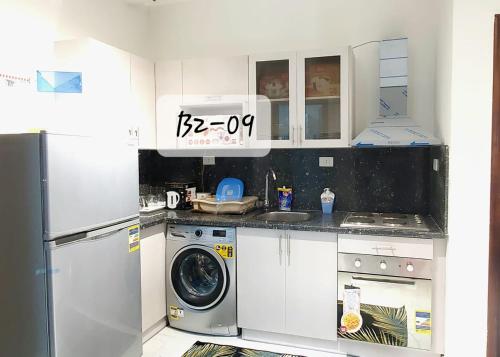 a kitchen with white cabinets and a washer and dryer at Seaview 2 Bedroom Private Deluxe Condo at Juliana Beach Resort B2-09 in Hurghada