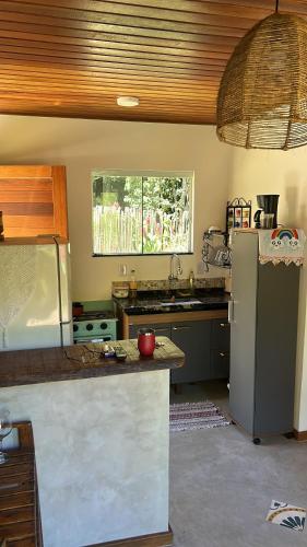 a kitchen with a stainless steel refrigerator and a sink at La Casinha da Sorte in Sana