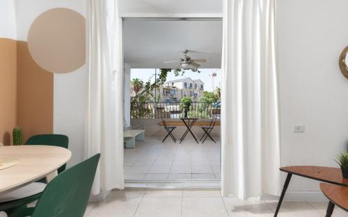 an open door to a patio with tables and chairs at Day'inn Eilat By The Beach in Eilat