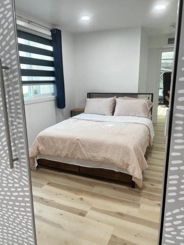 a bedroom with a bed and a mirror at Old Sunny Hills in Fullerton in Fullerton