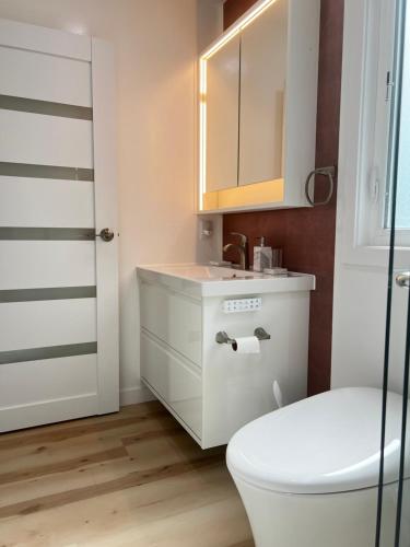 a bathroom with a toilet and a sink and a mirror at Old Sunny Hills in Fullerton in Fullerton