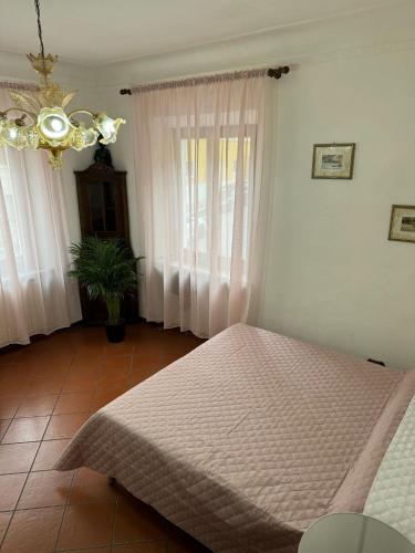 a bedroom with a bed and a chandelier at Residenza Brancondi in Loreto