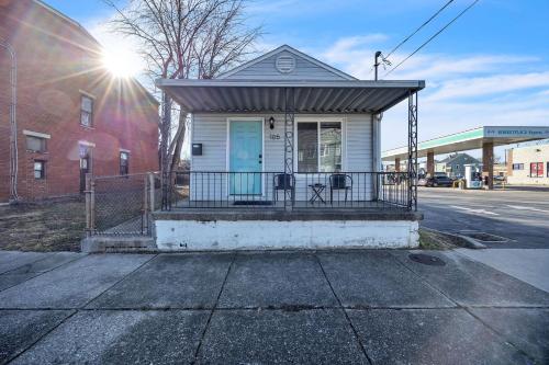 a small white house with a porch on a street at Charming Getaway on Ash St- Minutes from Cinci in Ludlow
