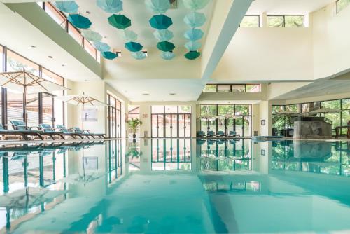 an indoor swimming pool with a large ceiling at Gokarna Forest Resort Pvt Ltd in Kathmandu
